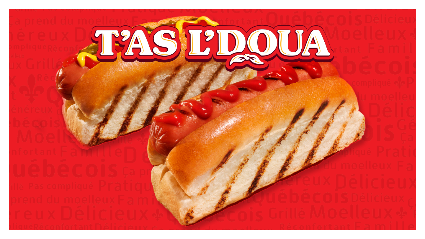 Two hot dogs on a red background featuring 'T'AS L'DOUA'.
